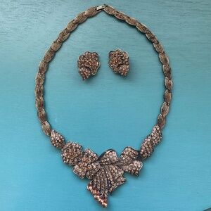 Statement necklace with clip on earrings, copper in color.